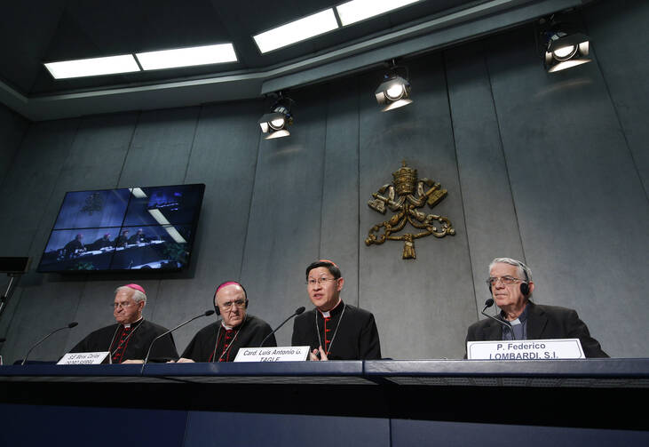 Prelates and the Vatican spokesman give a media briefing after the morning session of the Synod of Bishops on Oct. 9 (CNS/Paul Haring)
