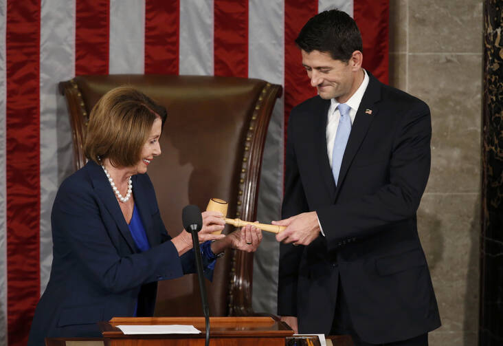 Former U.S. House Speaker and current Minority Leader Nancy Pelosi, D-Calif., hands incoming House Speaker Paul Ryan, R-Wis., the gavel after his election on Capitol Hill in Washington Oct. 29, 2015. (CNS photo/Gary Cameron, Reuters) 