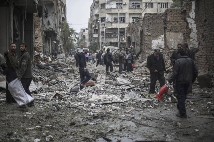 AFTERMATH. Survivors sift through the rubble of a destroyed field hospital in the rebel-held area of Douma on the outskirts of Damascus, on Oct. 29.