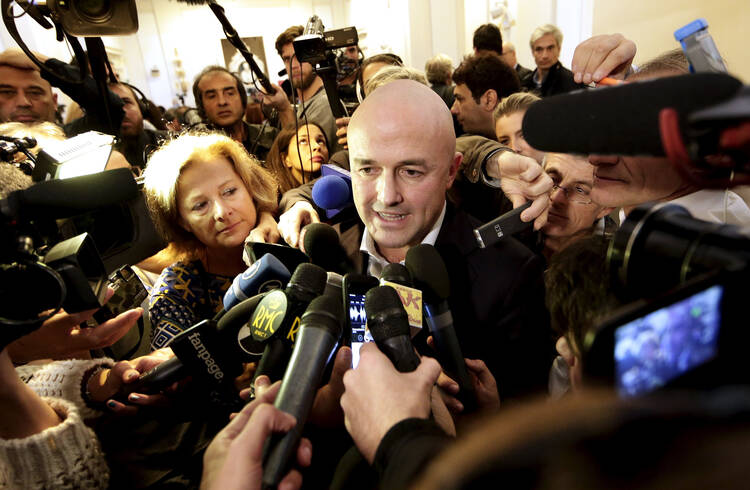 Italian journalist Gianluigi Nuzzi is surrounded by the media after a Nov. 4 news conference for his new book "Merchants in the Temple: Inside Pope Francis' Secret Battle Against Corruption in the Vatican." (CNS photo/Yara Nardi, Reuters)