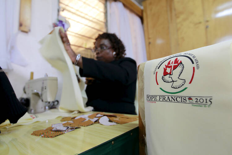 In this Oct. 22 photo, a tailor in Kangemi, outside Nairobi, Kenya, works on a vestment to be used by Pope Francis during his late-November trip to the country. (CNS photo/Thomas Mukoya, Reuters)