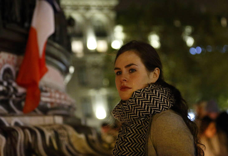 In Republique square in Paris on Nov. 14, people gather in memory of victims of terrorist attacks. Coordinated attacks the previous evening claimed the lives of 132 people. The Islamic State claimed responsibility. (CNS photo/Paul Haring)