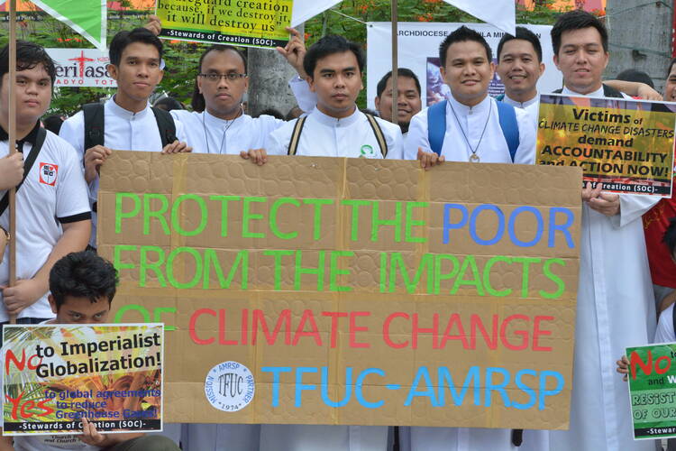 Seminarians join climate justice activists at a plaza in Manila, Philippines, Nov. 29, the day before the start of the U.N. climate change conference, known as the COP21 summit, in Paris. (CNS photo/Simone Orendain)