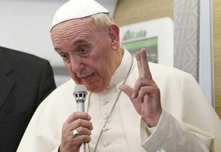 Pope Francis gestures as he answers questions from journalists aboard his flight from Bangui, Central African Republic, to Rome Nov. 30. (CNS photo/Paul Haring) 