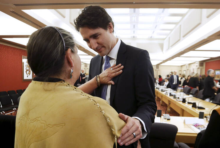 Prime Minister Justin Trudeau of Canada greets a woman upon the release of the Truth and Reconciliation Commission's final report in Ottawa in 2015. (CNS photo/Chris Wattie, Reuters)