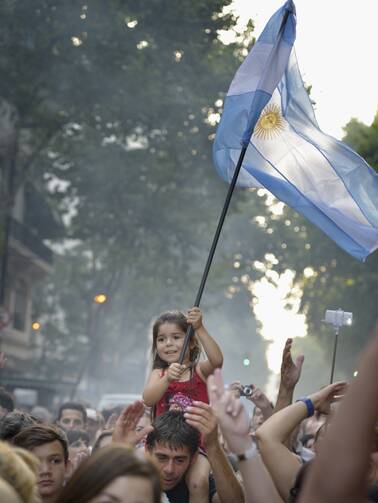 A girl carries an Argentine flag during a rally on President Cristina Fernandez de Kirchner's last day in office Dec. 10. (CNS photo/Paul Jeffrey) 