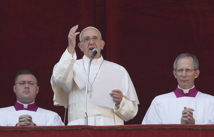 Pope Francis speaks after delivering his Christmas blessing "urbi et orbi" (to the city and the world) from the central balcony of St. Peter's Basilica at the Vatican Dec. 25. (CNS photo/Paul Haring) 