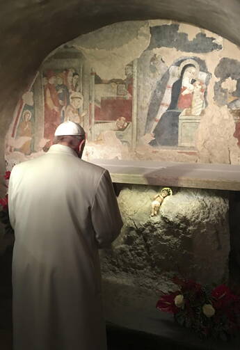 Pope Francis prays in front of a Nativity scene during a Jan. 4 surprise visit to the Franciscan shrine in Greccio, Italy. (CNS photo/L'Osservatore Romano, handout via EPA)