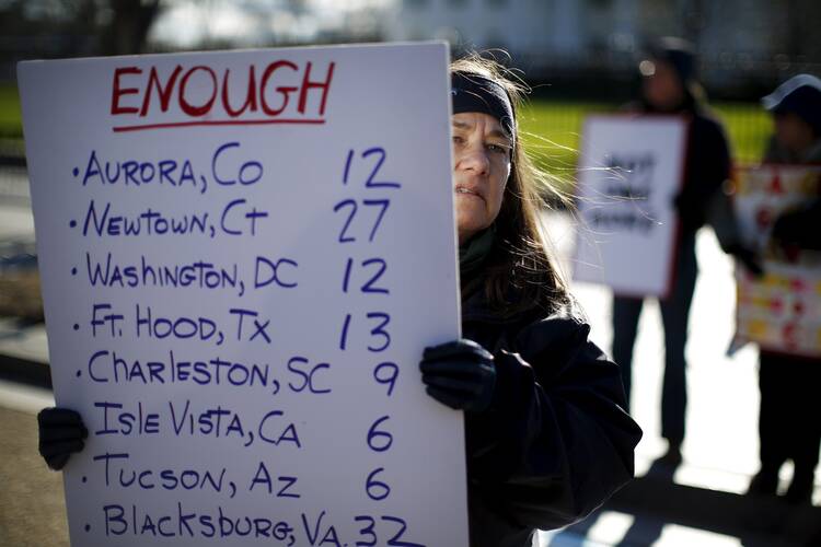Gun control activists rally in front of the White House in Washington Jan. 4. The next day, U.S. President Barack Obama announced executive actions to reduce gun violence. (CNS photo/Carlos Barria, Reuters)