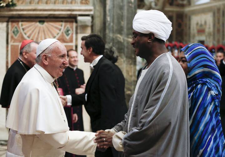 Pope Francis greets an ambassador during an audience with the diplomatic corps at the Vatican Jan.11. (CNS photo/Alessandro Bianchi, Reuters) 