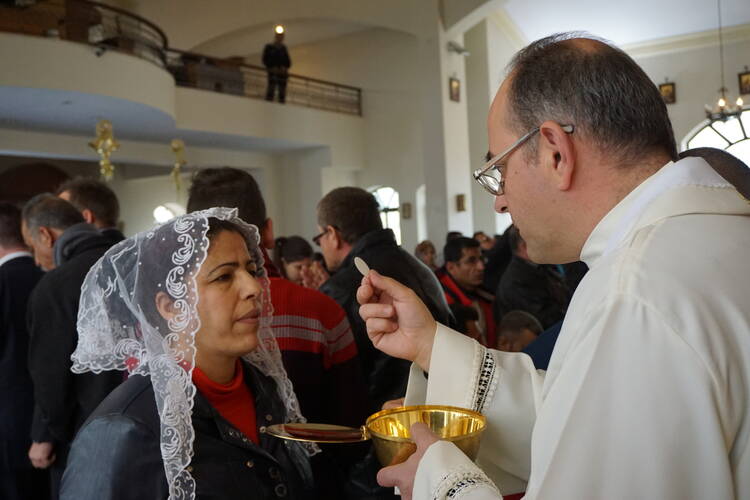 Mass for Iraqi Christian refugees at Our Lady of Peace Center on the outskirts of the Jordanian capital, Amman, in January 2016. (CNS photo/Dale Gavlak) 