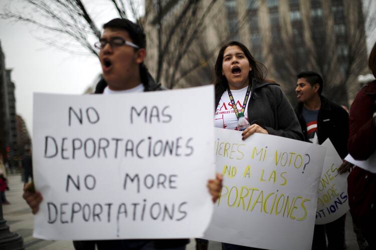 Demonstrators call for an end to deportations in a protest outside the White House in Washington in late December. (CNS photo/Carlos Barria, Reuters) 