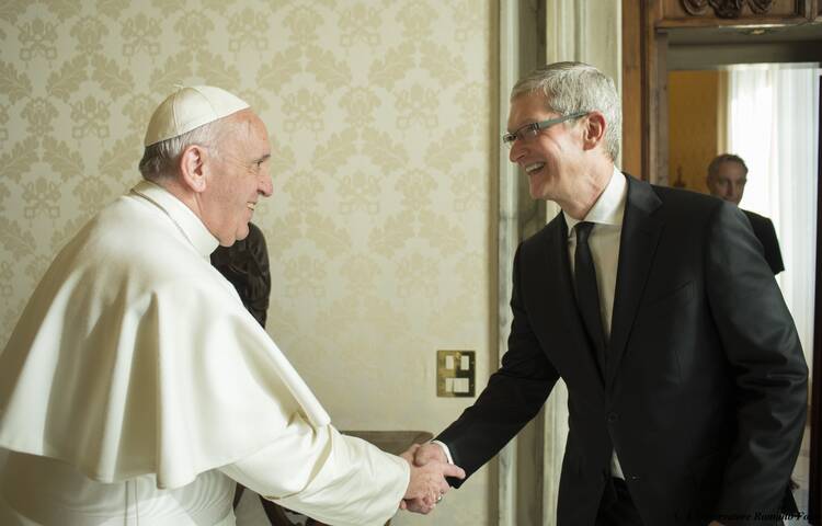 Pope Francis greets Apple CEO Tim Cook during a private audience in the Apostolic Palace at the Vatican Jan. 22. (CNS photo/L'Osservatore Romano, handout)