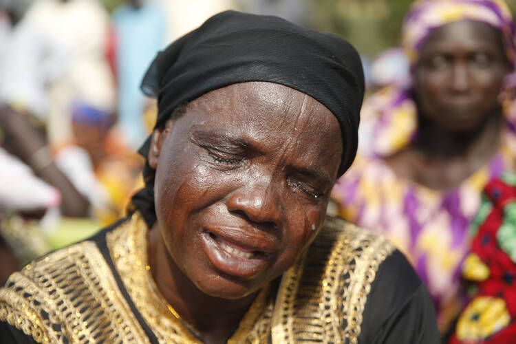 The mother of one of the missing Chibok girls, kidnapped by Boko Haram two years ago, reacts during a march in Abuja, Nigeria, in January. (CNS photo/Akintunde Akinleye, Reuters)