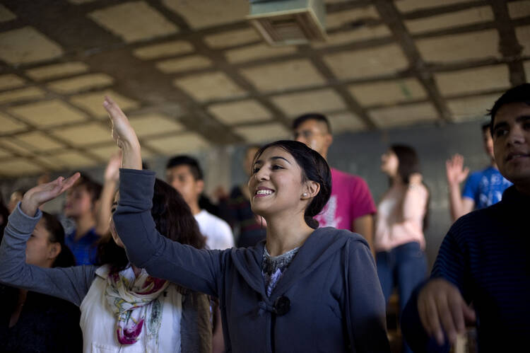 Diana Vega Flores, 18, sings during a Jan. 30 youth ministry program at Corpus Christi parish in Ciudad Juarez, Mexico. (CNS photo/David Maung)