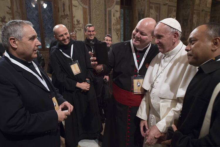 Pope Francis poses for a selfie during a Feb. 9 meeting with "missionaries of mercy" at the Vatican. (CNS photo/L'Osservatore Romano) 