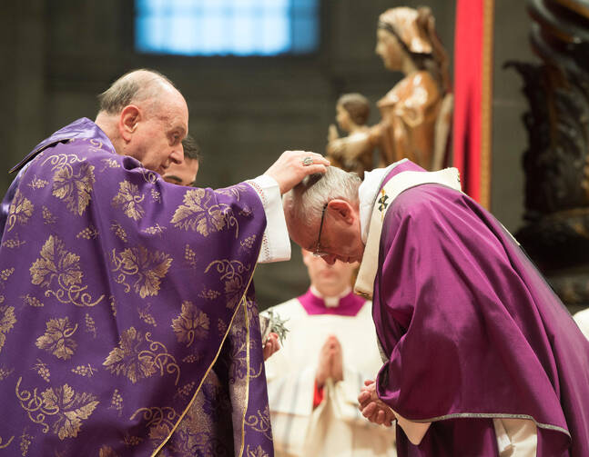 Cardinal Angelo Comastri, archpriest of St. Peter's Basilica, places ashes on Pope Francis' head during Ash Wednesday Mass in St. Peter's Basilica at the Vatican Feb. 10. (CNS photo/Paul Haring) 