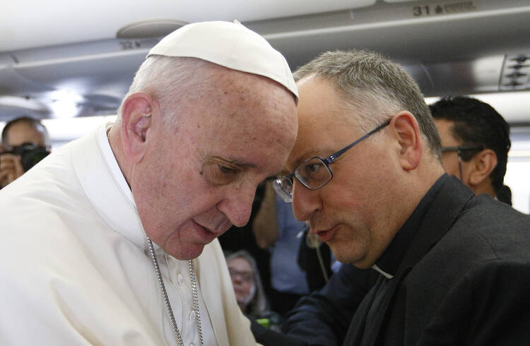 Pope Francis talks with Jesuit Father Antonio Spadaro, editor of La Civilta Cattolica, while meeting journalists aboard his flight to Havana Feb. 12. Traveling to Mexico for a six-day visit, the pope is stopping briefly in Cuba to meet with Russian Orthodox Patriarch Kirill of Moscow at the Havana airport. (CNS photo/Paul Haring)