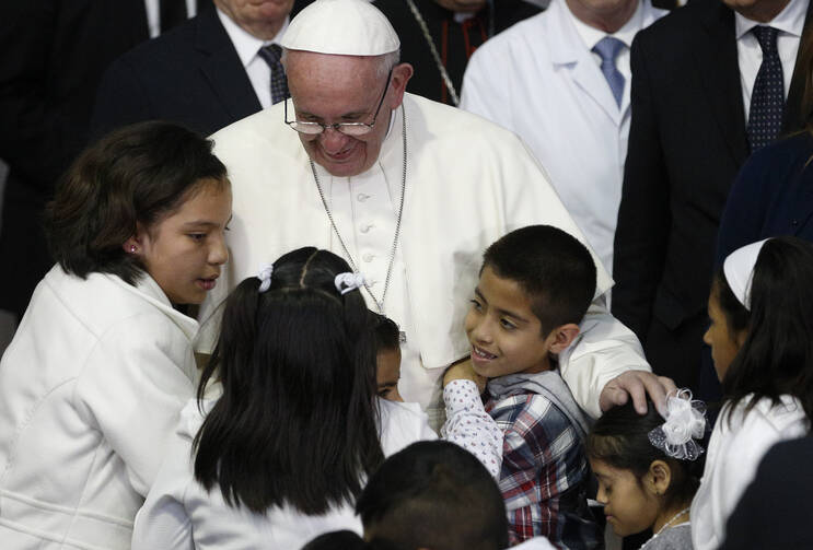 Pope Francis embraces children during a visit to the Federico Gomez Children's Hospital of Mexico in Mexico City Feb. 14. (CNS photo/Paul Haring)
