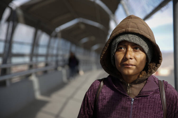 Diana Martinez, who had been deported from the United States, stands on the bridge linking El Paso, Texas, and Juarez, Mexico, in February 2016. (CNS photo/Nancy Wiechec)