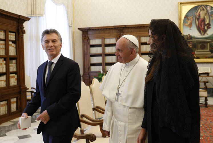 Pope Francis walks with Argentinian President Mauricio Macri and his wife Juliana Awada during a private audience in the Apostolic Palace at the Vatican Feb. 27. (CNS photo/Paul Haring)