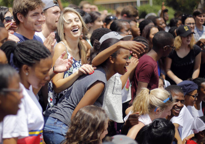 Young people gather for a group photo after a Mass for peace at the University of Pretoria in South Africa Feb. 25. (CNS photo/Kim Ludbrook, EPA)