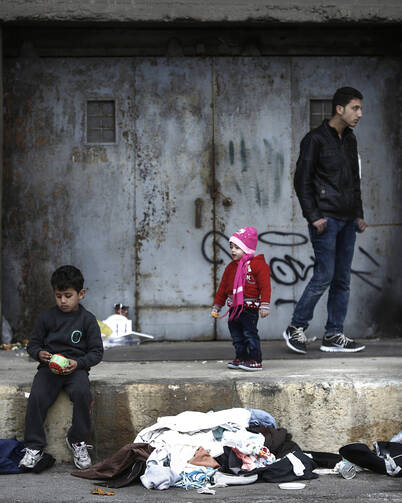 Refugees and migrants find shelter outside a passenger terminal near Athens, Greece, Feb. 29. (CNS photo/Yannis Kolesidis, EPA)