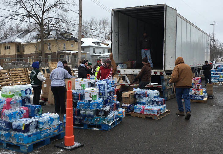 Volunteers stack water bottles in Lansing, Mich., Feb. 15. (CNS photo/courtesy FAITH Catholic)