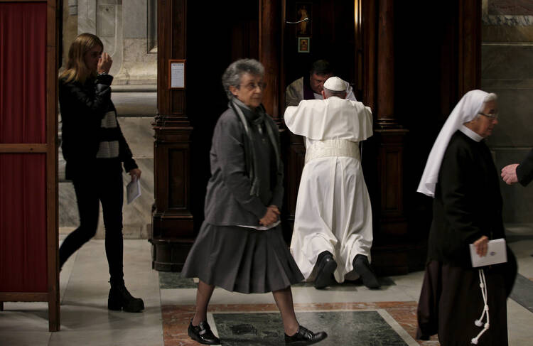 Pope Francis confesses in St. Peter's Basilica at the Vatican March 4. (CNS photo/Max Rossi, Reuters)