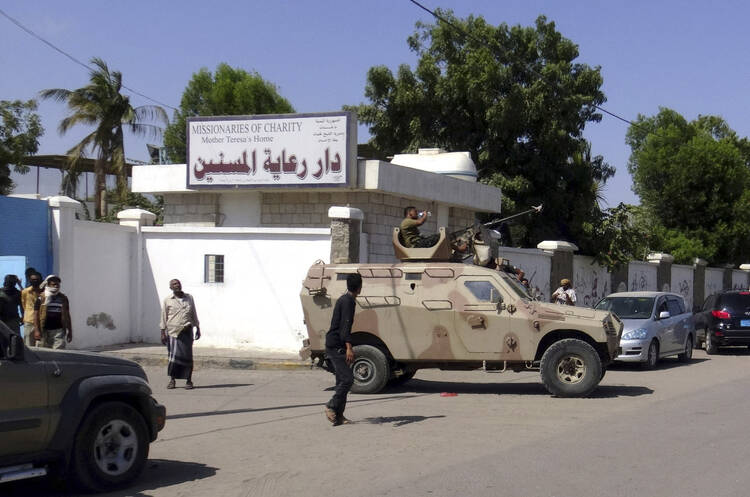 Yemeni pro-government fighters guard outside a Missionaries of Charity elderly home March 4 after unidentified gunmen targeted the home in Aden, Yemen. Four Missionaries of Charity and 10 to 12 other people were killed in the attack. (CNS photo/EPA)