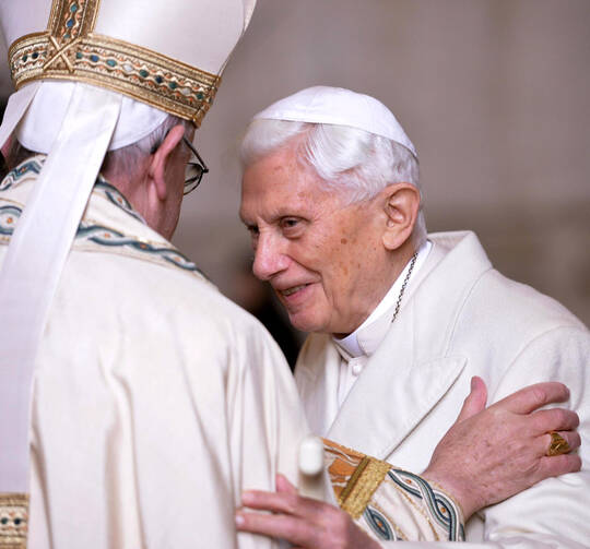 Pope Francis greets retired Pope Benedict XVI prior to the opening of the Holy Door of St. Peter's Basilica at the Vatican in 2015. (CNS photo/Maurizio Brambatti, EPA)