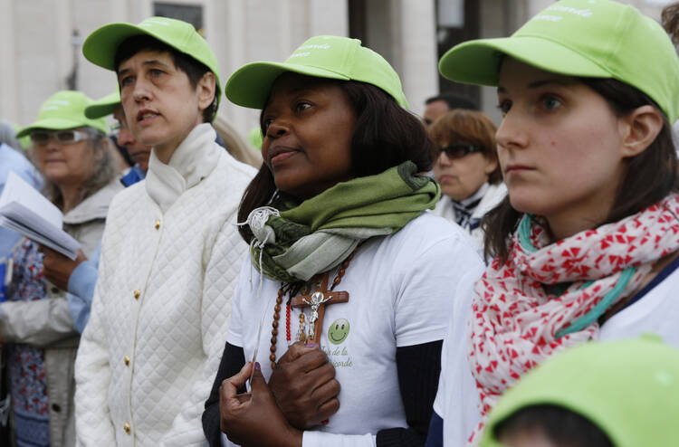 Pilgrims participate in a prayer service led by Pope Francis on the eve of the feast of Divine Mercy in St. Peter's Square at the Vatican April 2. (CNS photo/Paul Haring)