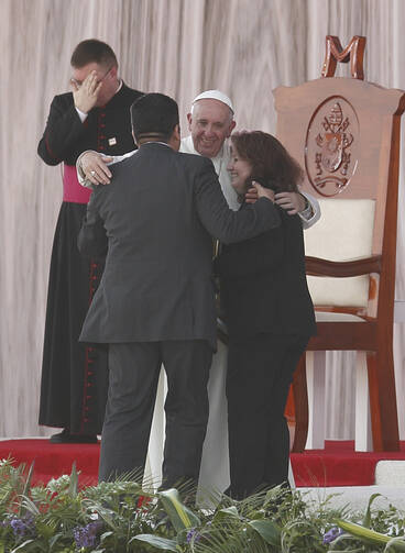 Pope Francis embraces Humberto and Claudia Gomez, who are married civilly but not in the church, during a meeting with families at the Victor Manuel Reyna Stadium in Tuxtla Gutierrez, Mexico, Feb. 15.