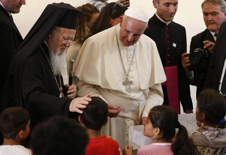  Ecumenical Patriarch Bartholomew of Constantinople and Pope Francis meet children at the Moria refugee camp on the island of Lesbos, Greece, April 16, 2016. (CNS photo/Paul Haring) 