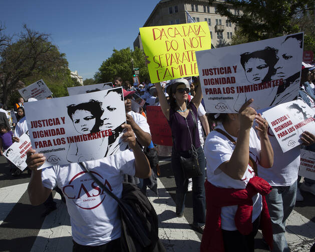 Demonstrators gather outside the U.S. Supreme Court in Washington April 18 as the justices hear oral arguments in a challenge by several states to President Barack Obama's deferred deportation programs. (CNS photo/Tyler Orsburn)