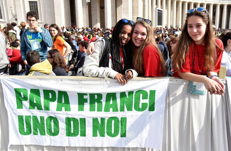 Young pilgrims display a banner that says "Pope Francis One of us" as the pontiff celebrates Mass for the Youth Jubilee in St. Peter's Square at the Vatican in April 2016. (CNS photo/Ettore Ferrari, EPA)
