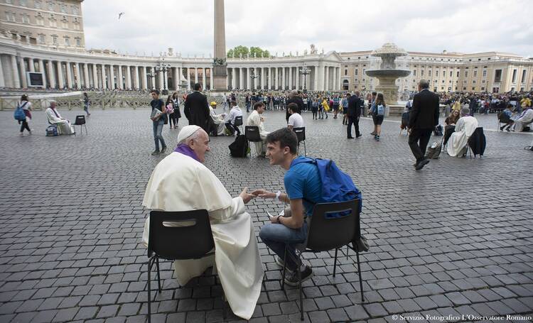 Pope Francis hears confession of a youth April 23 in St. Peter's Square at the Vatican. (CNS photo/L'Osservatore Romano via Reuters)