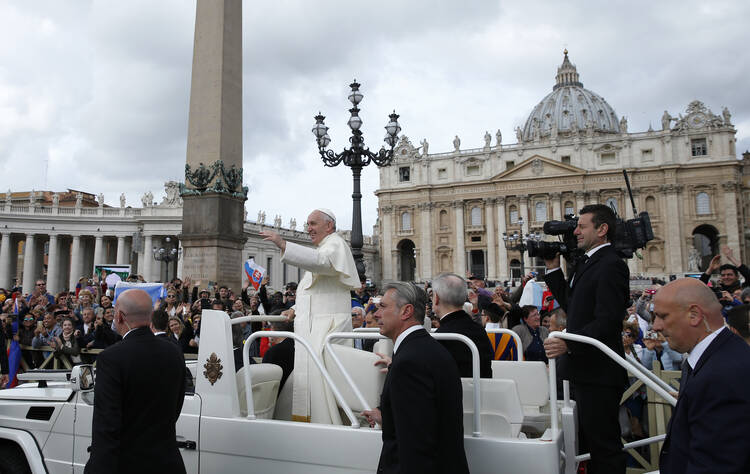 Pope Francis greets the crowd during his general audience in St. Peter's Square at the Vatican April 27. (CNS photo/Paul Haring) 