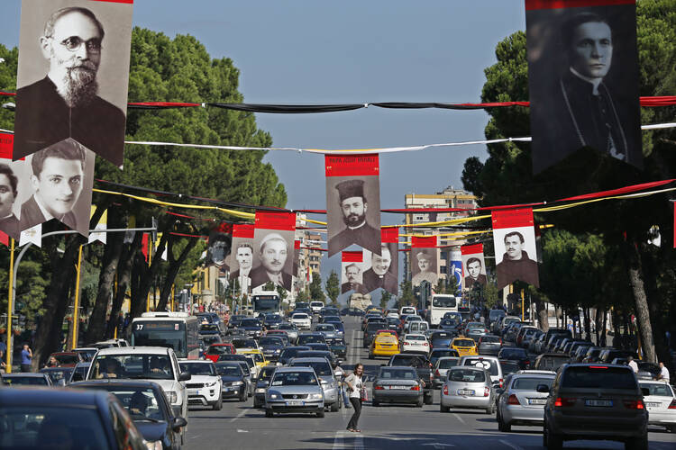 Photographs of Albanian priests killed during the former communist regime hang in the main boulevard of Tirana, Albania, Sept. 17, 2014. (CNS photo/Armando Babani, EPA)