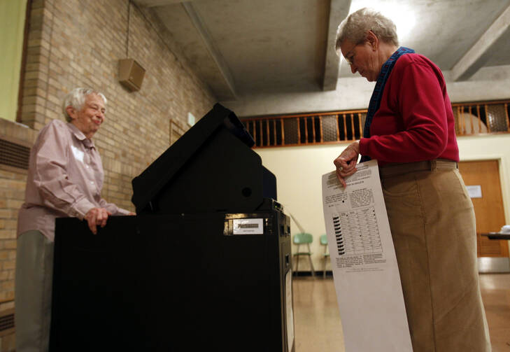 A Maryknoll sister casts her vote at a polling station inside her religious community's auditorium in 2010 in Ossining, N.Y. (CNS photo/Jessica Rinaldi, Reuters)