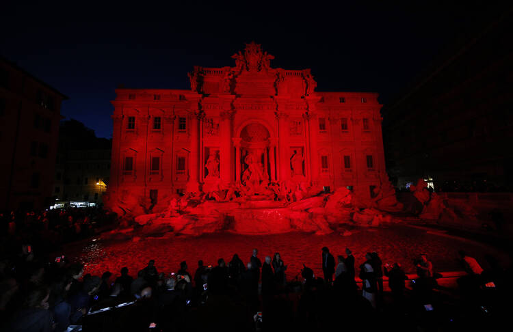 The Trevi Fountain in Rome is lit in red during an event to raise awareness of the plight of Christian martyrs April 29. (CNS photo/Paul Haring)