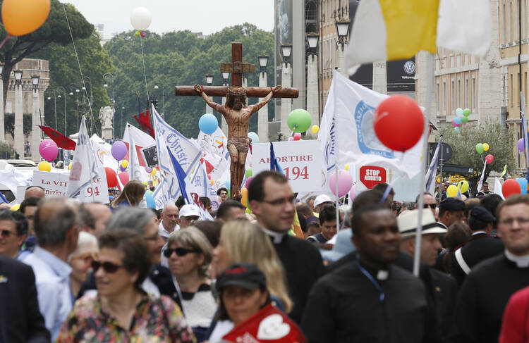 A large crucifix is seen as people participate in the 6th annual March for Life in Rome May 8. The march ended outside St. Peter's Square at the Vatican where Pope Francis was leading the Regina Coeli. (CNS photo/Paul Haring) 