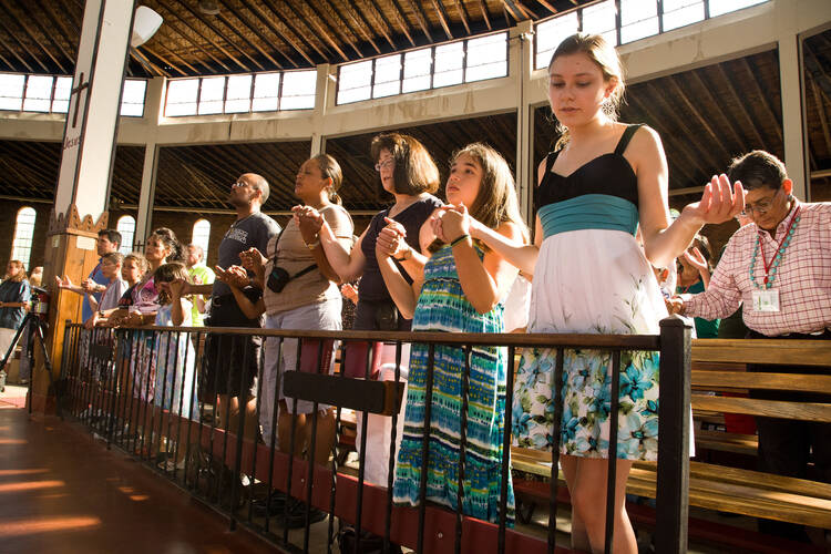 In this July 21, 2012, file photo, people pray during a Mass marking the end of the 73rd annual Tekakwitha Conference at the Shrine of Our Lady of Martyrs in Auriesville, N.Y., the birthplace of St. Kateri Tekakwitha. (CNS photo/Glenn Davenport)