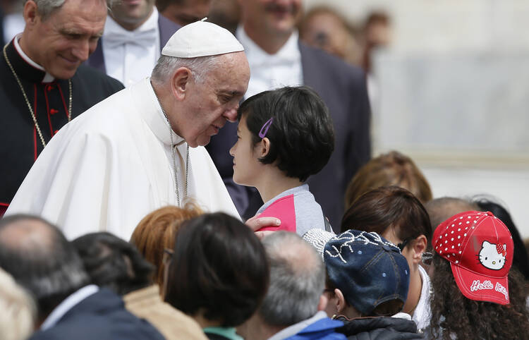 Pope Francis greets a young woman as he meets the disabled during his general audience in St. Peter's Square at the Vatican June 1. (CNS photo/Paul Haring)