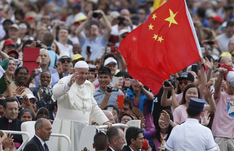 China's flag is seen as Pope Francis greets the crowd during his general audience in St. Peter's Square at the Vatican June 15. (CNS photo/Paul Haring