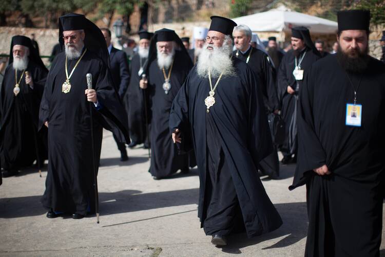 Orthodox patriarchs and primates walk at the Orthodox Academy of Crete as they meet to consider a draft message of the Great and Holy Council of the Orthodox Church in Chania on the Greek island of Crete, June 17 (CNS photo/Sean Hawkey, handout).