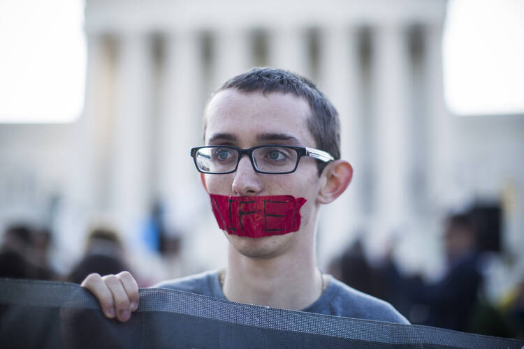 A young pro-life supporter stands outside the U.S. Supreme Court June 26 during protests in Washington. (CNS photo/Jim Lo Scalzo, EPA)