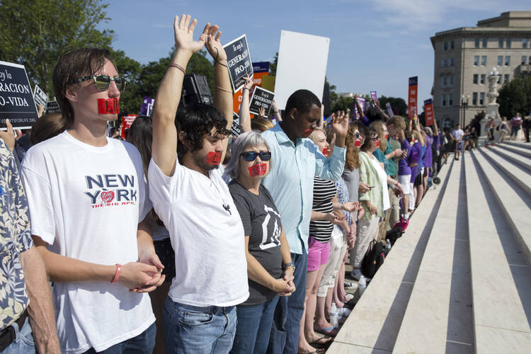 Pro-life supporters pray at the steps of the U.S. Supreme Court June 27 during protests in Washington. In a 5-3 vote that day, the U.S. Supreme Court struck down restrictions on Texas abortion clinics. (CNS photo/Michael Reynolds, EPA)