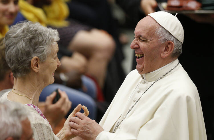 Pope Francis laughs as he greets a woman during an audience with people from Lyon, France, in Paul VI hall at the Vatican July 6. The audience was with 200 people living in difficult or precarious situations. (CNS photo/Paul Haring) 