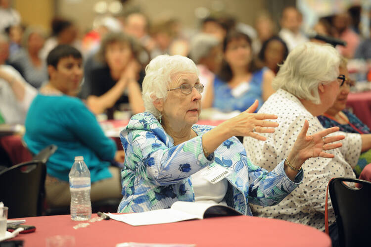 An attendee gestures on July 7 during a national symposium on domestic violence held at The Catholic University of America in Washington. (CNS photo/Dana Rene Bowler, CUA)